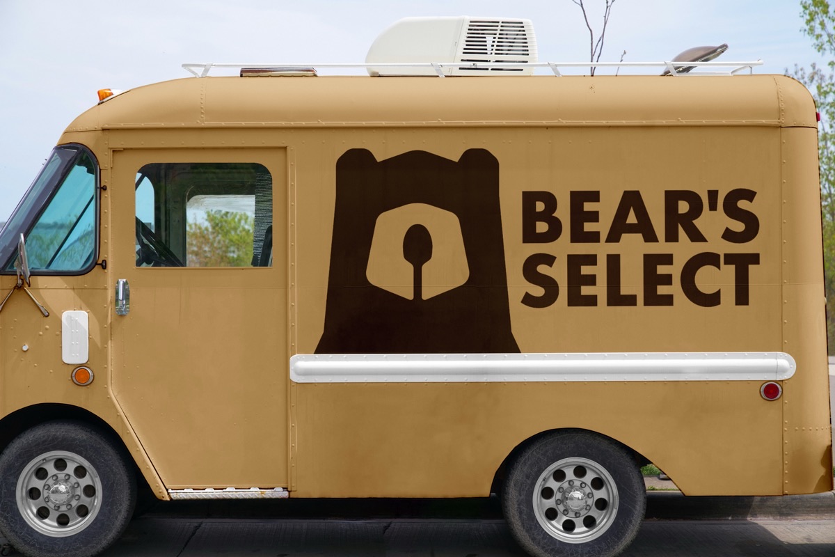 The Bear's Select lockup mocked up on the side panel of a cream ice cream truck.